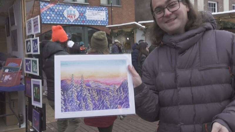 Shopper Ethan Brodie of Alexandria, Virginia holds up his purchase from the Burlington Winter...