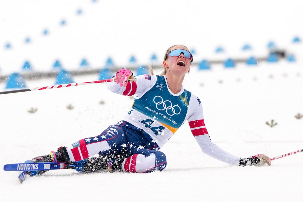 Jessie Diggins, of the United States, falls to the ground after crossing the finish line in...