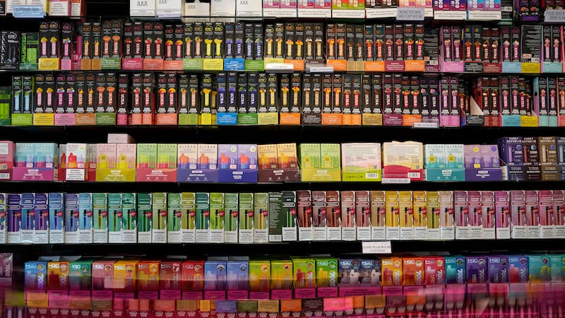 FILE - Disposable flavored electronic cigarette devices are displayed for sale at a store in...