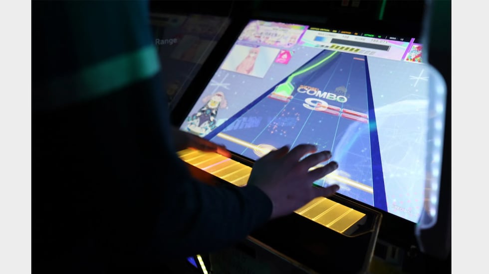 Someone plays Chunithm at The Dragon's Dojo.