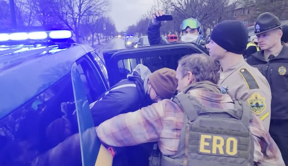 Police arrest a protester in South Burlington on Wednesday.