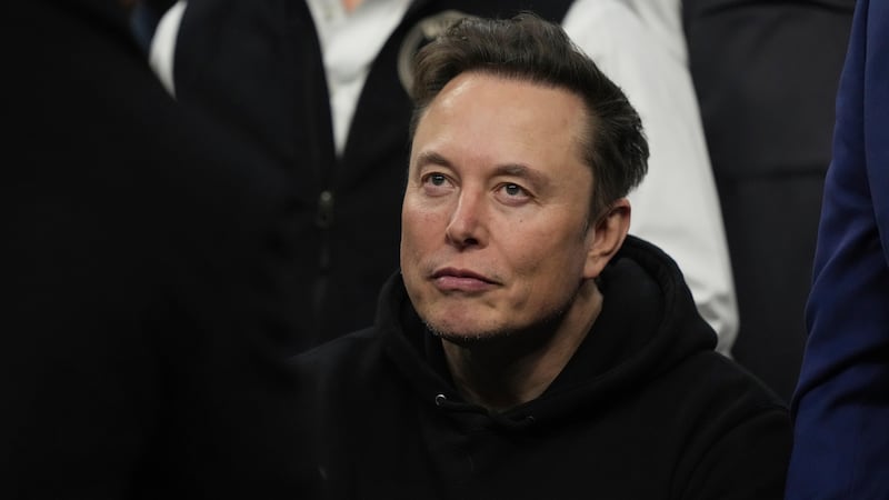 FILE - Elon Musk attends the finals for the NCAA wrestling championship, March 22, 2025, in...